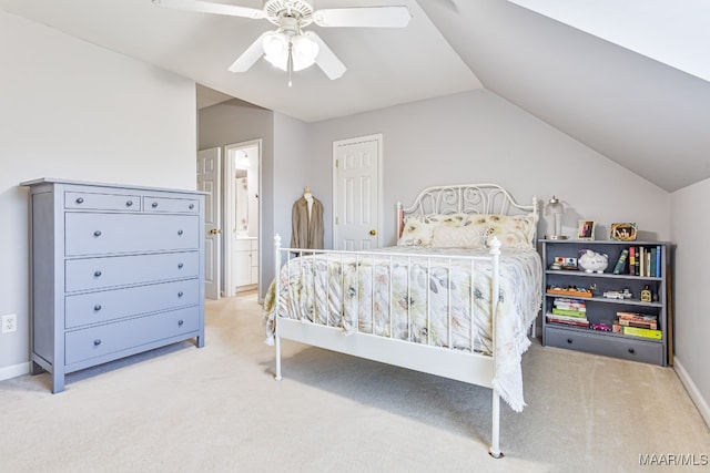 carpeted bedroom with ceiling fan, lofted ceiling, and ensuite bathroom