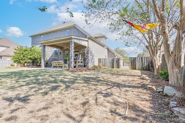 rear view of property with a patio area and a lawn