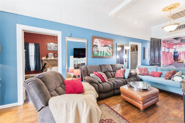 living room with hardwood / wood-style floors and beamed ceiling