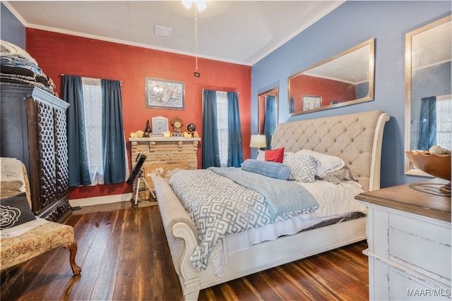 bedroom with crown molding and dark hardwood / wood-style floors