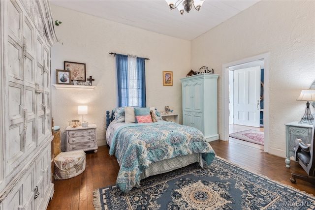 bedroom with dark hardwood / wood-style floors