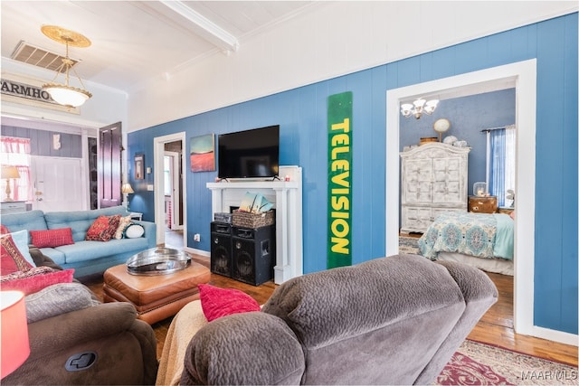 living room featuring beam ceiling, crown molding, and hardwood / wood-style flooring