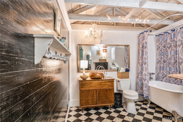 bathroom with wood ceiling, toilet, beamed ceiling, wooden walls, and vanity