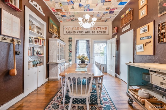 dining space featuring a notable chandelier and dark hardwood / wood-style floors