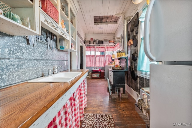 kitchen featuring sink, dark wood-type flooring, wood ceiling, and a healthy amount of sunlight