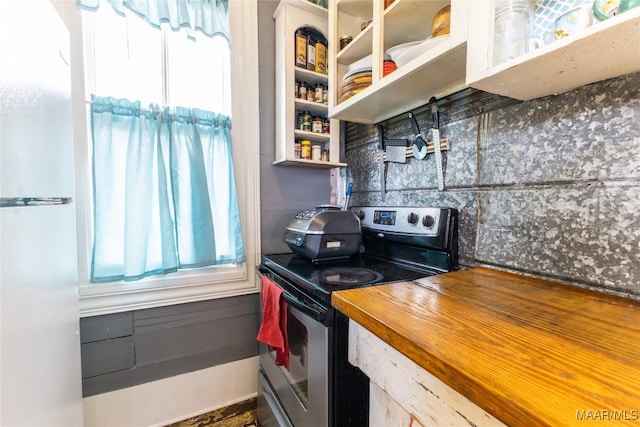 kitchen with white fridge and stainless steel range with electric cooktop