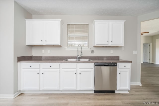 kitchen featuring white cabinetry, a textured ceiling, stainless steel dishwasher, light hardwood / wood-style flooring, and sink