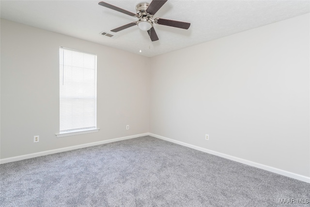 carpeted empty room featuring ceiling fan and a healthy amount of sunlight