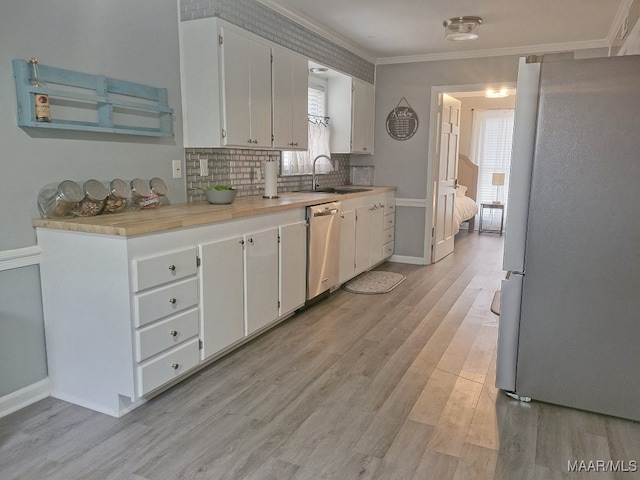 kitchen featuring light hardwood / wood-style floors, white cabinets, stainless steel appliances, and plenty of natural light