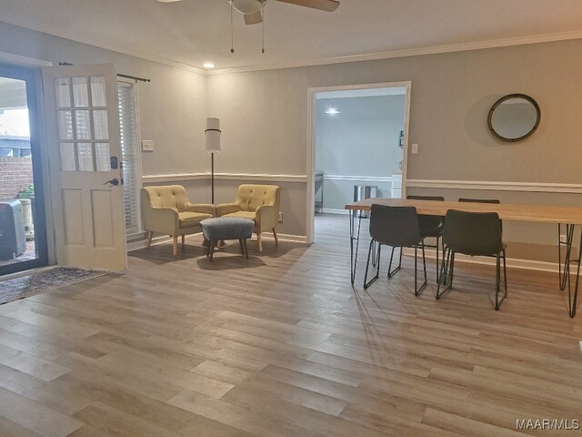 sitting room with ornamental molding, light wood-type flooring, and ceiling fan