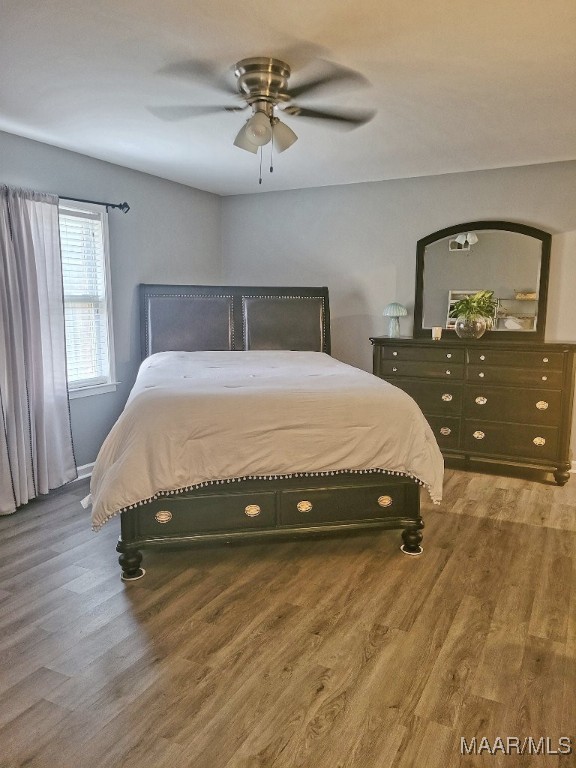 bedroom featuring ceiling fan and wood-type flooring