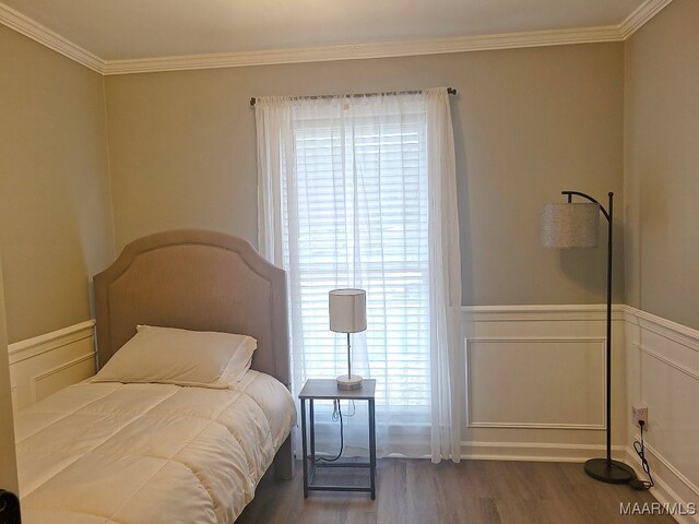 bedroom featuring crown molding, multiple windows, and dark hardwood / wood-style flooring