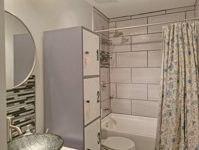 bathroom featuring shower / bath combo, toilet, and tasteful backsplash