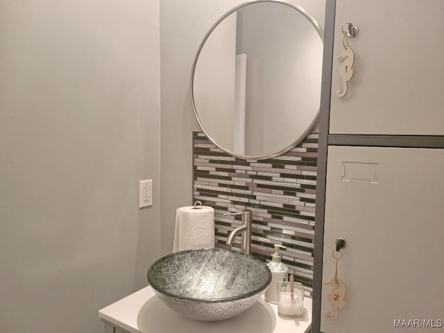 bathroom featuring vanity and decorative backsplash