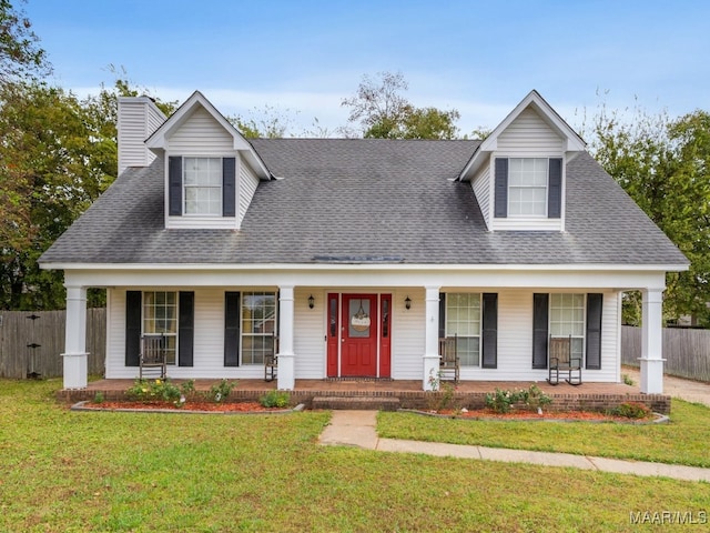 new england style home featuring a porch and a front yard