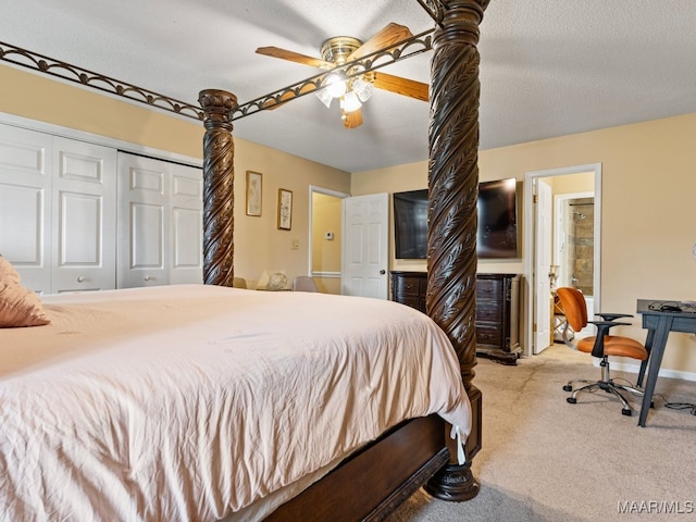 bedroom featuring ceiling fan, light colored carpet, a textured ceiling, and a closet