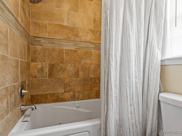 bathroom with shower / bathtub combination with curtain and toilet