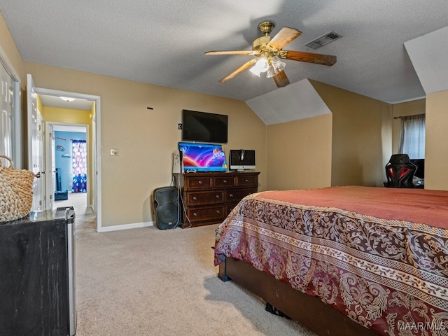 bedroom featuring vaulted ceiling, ceiling fan, light colored carpet, and a textured ceiling