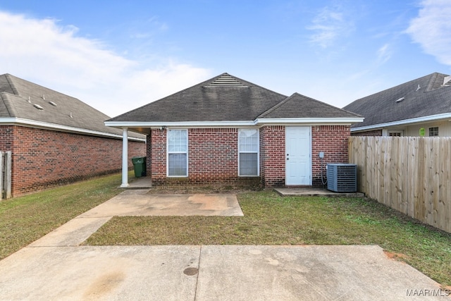 back of property featuring central air condition unit, a patio area, and a lawn