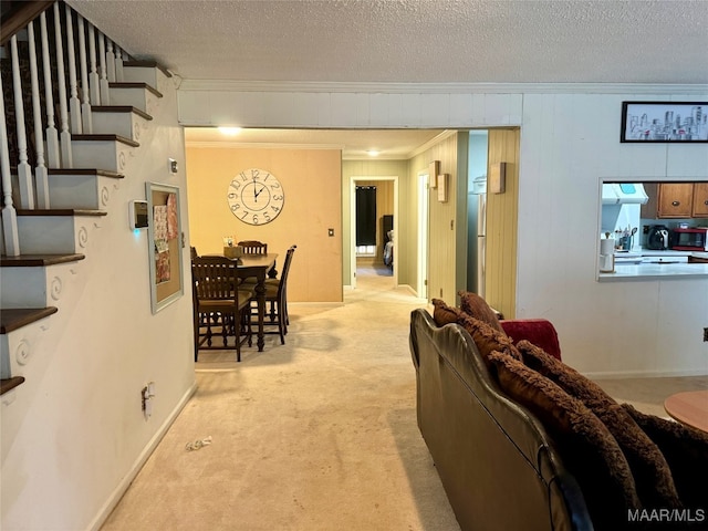 living room with light carpet, ornamental molding, and a textured ceiling