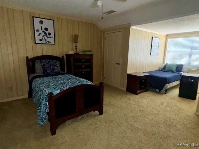 bedroom with ceiling fan, lofted ceiling, ornamental molding, and carpet floors