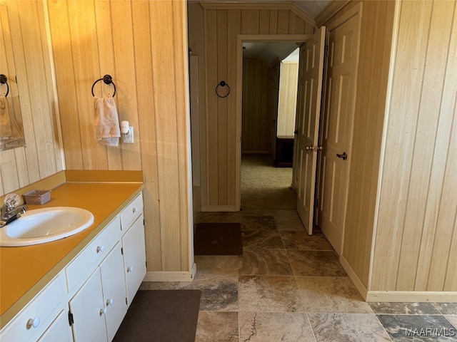 bathroom featuring vanity and wooden walls