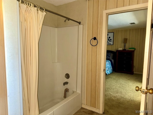 bathroom featuring shower / tub combo with curtain and wood walls