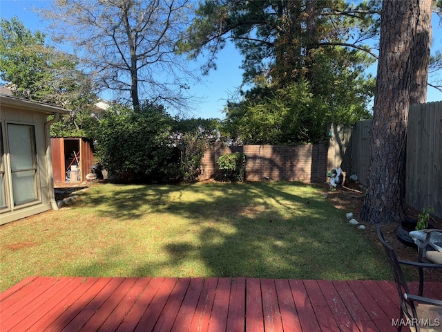 view of yard with a storage shed and a wooden deck