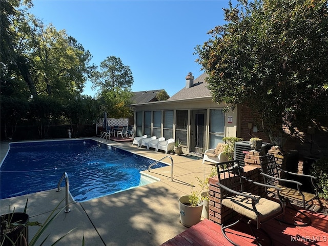 view of swimming pool featuring a patio area