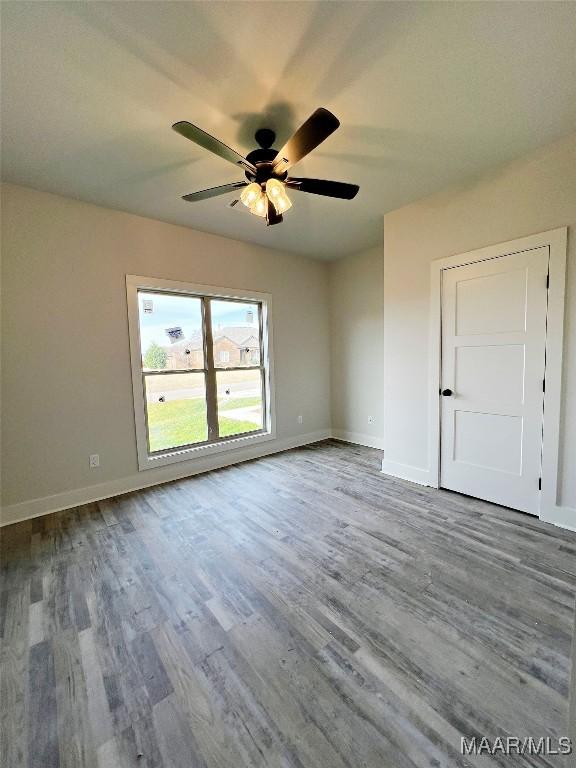 empty room featuring hardwood / wood-style floors and ceiling fan