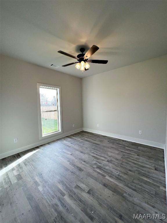 unfurnished room featuring ceiling fan and dark hardwood / wood-style floors