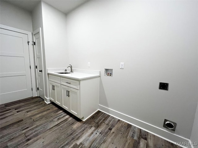 washroom with hookup for an electric dryer, dark wood-style flooring, washer hookup, a sink, and cabinet space