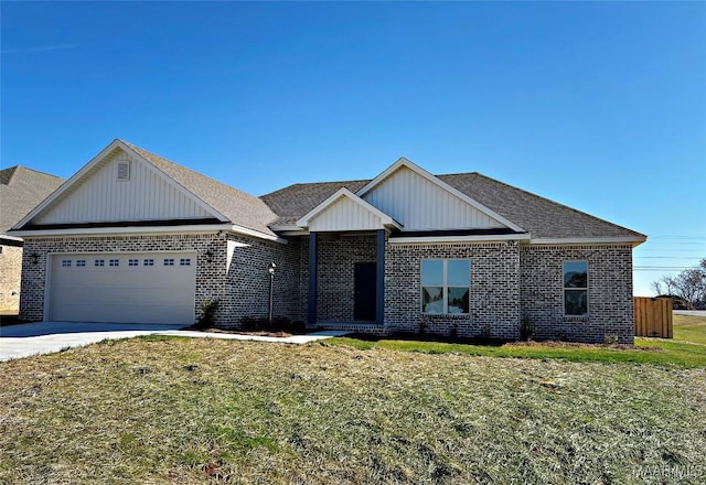 view of front of home featuring a garage, driveway, a front yard, and brick siding