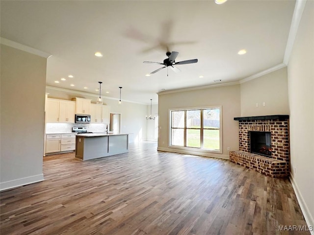 unfurnished living room featuring ceiling fan, a fireplace, wood finished floors, and baseboards