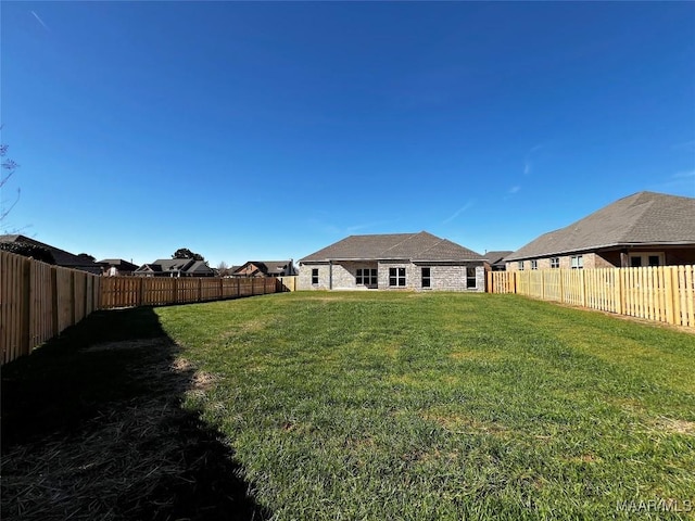 view of yard featuring a fenced backyard