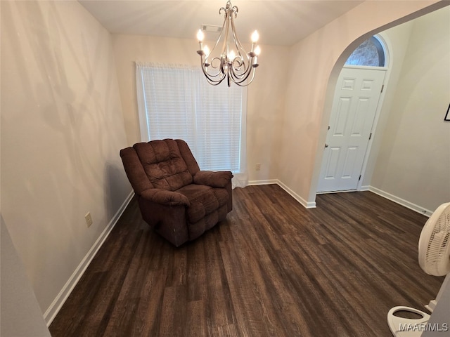 living area with dark hardwood / wood-style floors and a chandelier