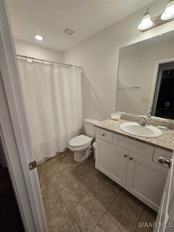 bathroom with vanity, curtained shower, toilet, and tile patterned floors