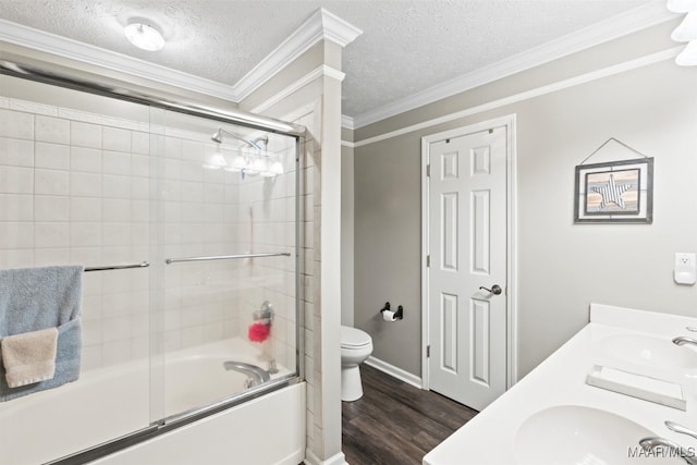 full bathroom with bath / shower combo with glass door, a textured ceiling, wood-type flooring, toilet, and ornamental molding