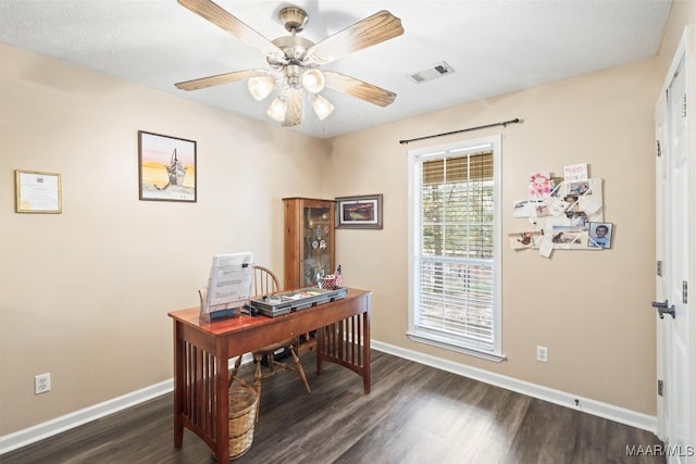 home office with dark wood-type flooring and ceiling fan