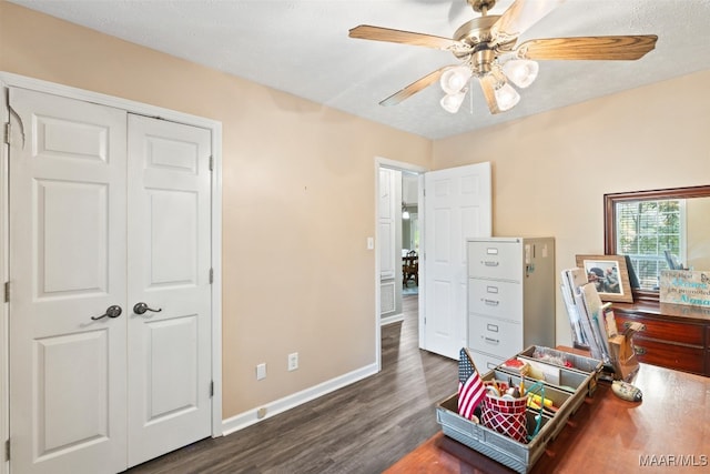 interior space with a textured ceiling, dark hardwood / wood-style floors, and ceiling fan