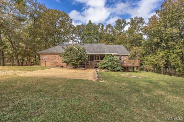 exterior space with a patio, a wooden deck, and a lawn