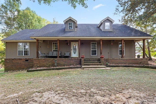 view of front of house with a front yard and covered porch