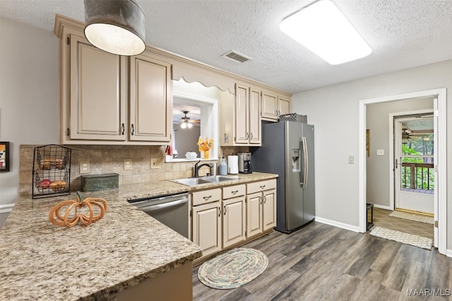 kitchen with ceiling fan, appliances with stainless steel finishes, dark hardwood / wood-style flooring, a textured ceiling, and sink