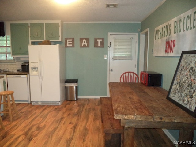 dining area featuring crown molding and hardwood / wood-style floors