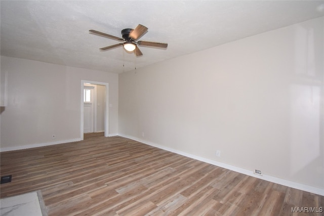 unfurnished room with hardwood / wood-style floors, a textured ceiling, and ceiling fan