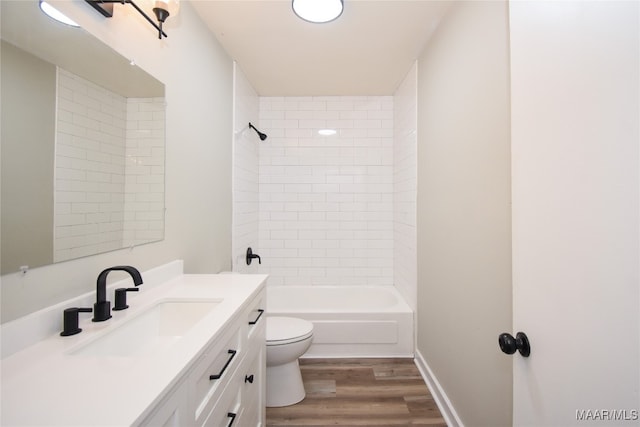 full bathroom with vanity, toilet, hardwood / wood-style flooring, and tiled shower / bath combo