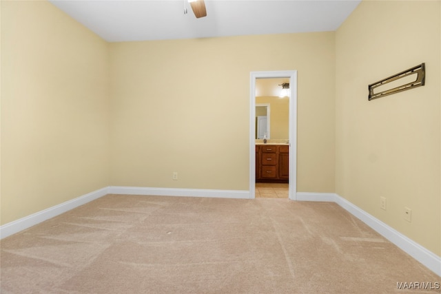 carpeted empty room featuring ceiling fan