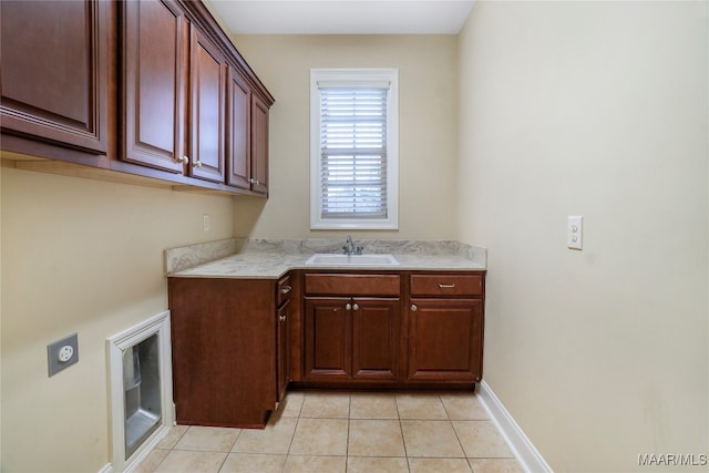 kitchen featuring light tile patterned floors and sink