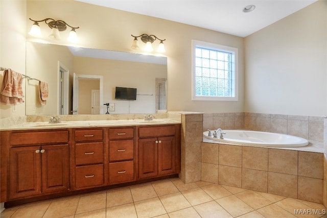 bathroom featuring vanity, tile patterned floors, and a relaxing tiled tub