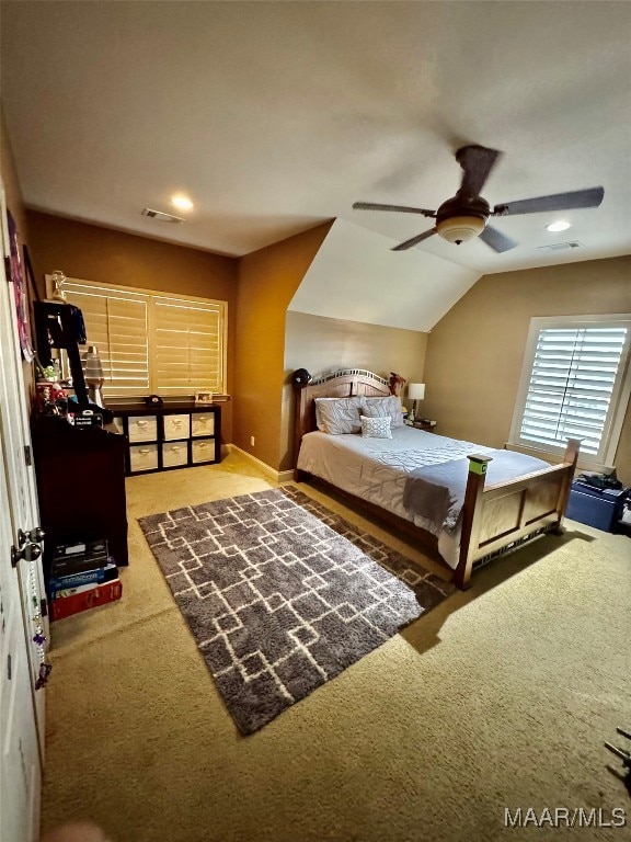 carpeted bedroom featuring ceiling fan and vaulted ceiling